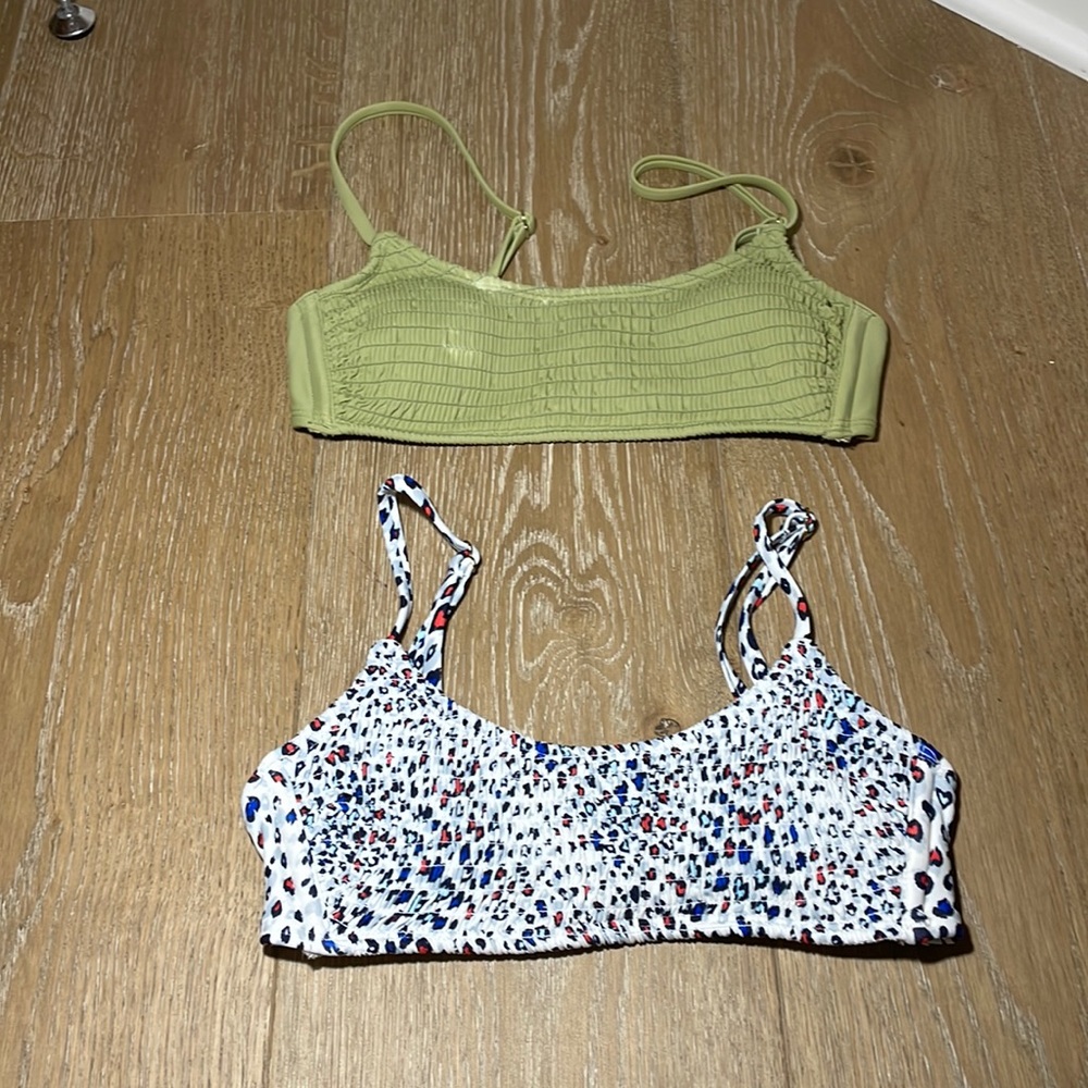 a green bikini top and a red white and blue bikini top